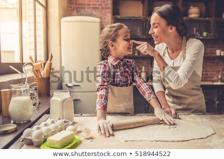 Stockfoto: Happy Mother And Daughter Baking Muffins At Home