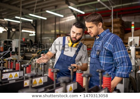 Stock foto: Bearded Engineer Explaining Principles Of Work Of New Processing Equipment