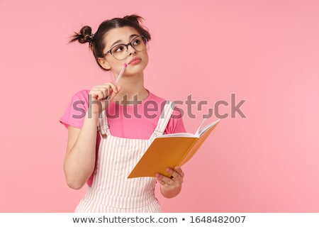 Сток-фото: Photo Of Serious Charming Girl Holding Exercise Book And Thinking