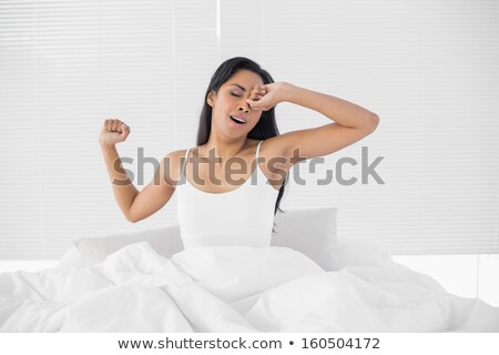 ストックフォト: Bright Woman Yawning Sitting On Her Bed