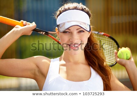 Stock photo: Smiling Woman With Tennis Racquet Looking At Camera