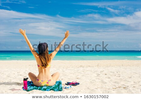 Stok fotoğraf: Beautiful Girl In A Bathing Suit Sunning On The Beach