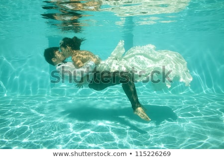ストックフォト: Bride And Groom In Pool With Bubbles