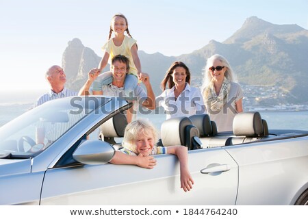 Stock foto: Grandparents Carrying Their Grandchildren On Shoulder