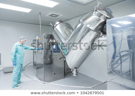 [[stock_photo]]: Pharmaceutical Factory Man Worker In Protective Clothing Working With Control Panel In Sterile Worki