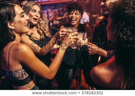 Stok fotoğraf: Group Of Friends Enjoying A Drink In The Bar