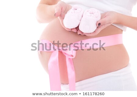 Foto stock: Close Up Of Pregnant Woman With Baby Bootees