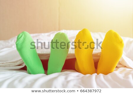 Stock photo: Close Up Of Familys Feet Relaxing On Bed At Home