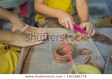 Stok fotoğraf: Mother And Son Doing Ceramic Pot In Pottery Workshop