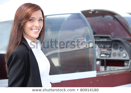 Foto d'archivio: Female Pilot Standing Next To The Cockpit Of A Light Aircraft