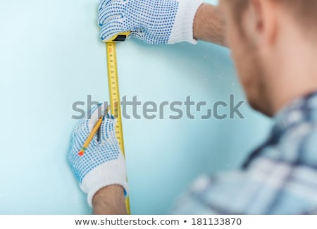 Stockfoto: Man Measuring Wall