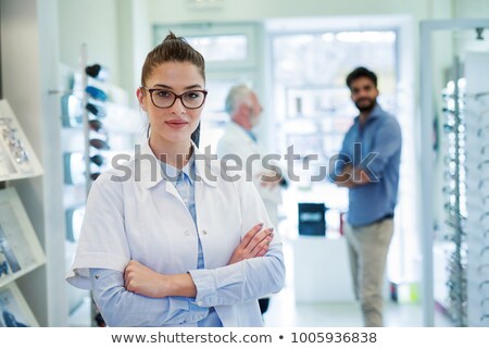 Stock foto: Female Optician Standing In Front Of Eyesight Test At Hospital