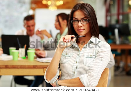 Сток-фото: Young Brunette Business Woman With Glasses With Pen Thinking