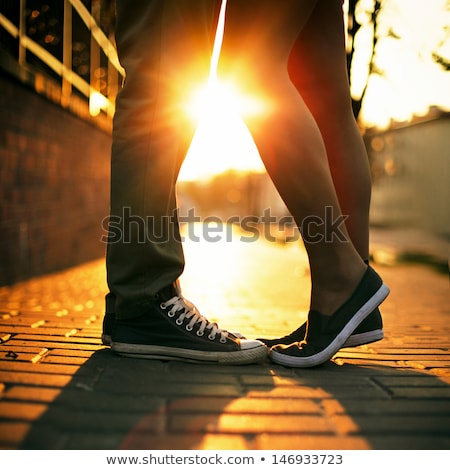 Foto stock: Happy Young Couple Standing At The Beach And Kissing