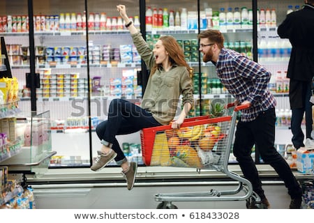 ストックフォト: Happy Loving Couple In Supermarket With Shopping Trolley