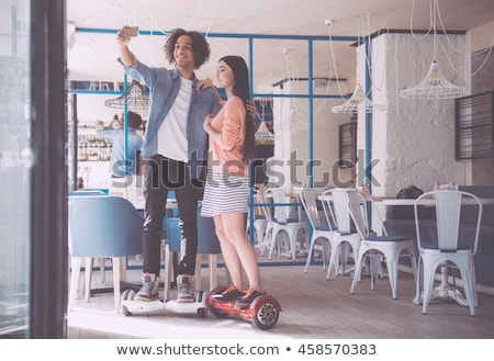 Stock foto: A Young Couple Riding Hoverboard - Electrical Scooter Personal