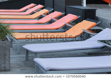 [[stock_photo]]: Rows Of Beach Parasols With Buildings