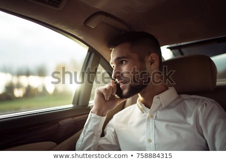 Stock photo: Businessman Sitting Inside Car Talking On Cellphone