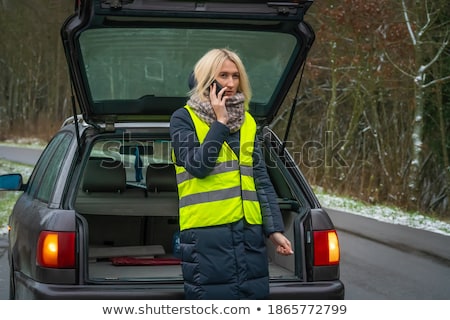 Сток-фото: Girl On The Winter Road Is Calling The Phone Near The Car