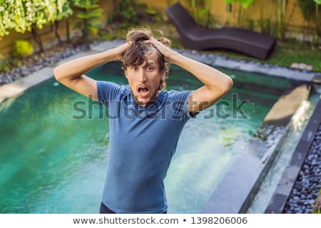 Stock foto: Pool Worker Checks The Pool For Safety Measurement Of Chlorine And Ph Of A Pool