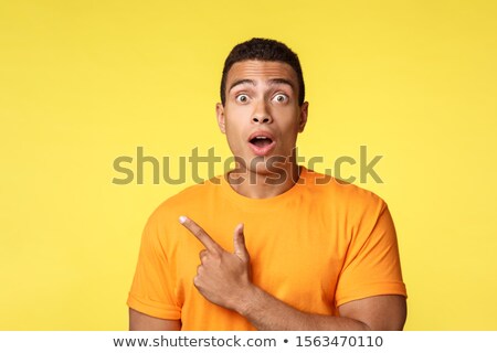 [[stock_photo]]: Surprised Overwhelmed Young Handsome Guy In T Shirt Realising Something Awesome Happening Enjoy I