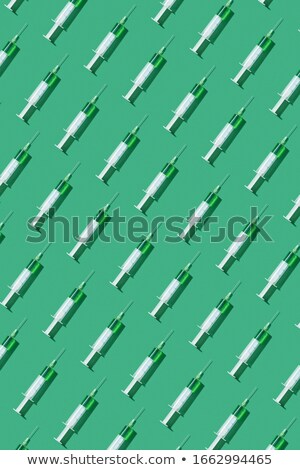 Stock fotó: Sterile Syringe Of Green Liquid Or Vaccine With Shadow