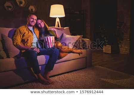 ストックフォト: Cheerful Couple Sitting On A Sofa