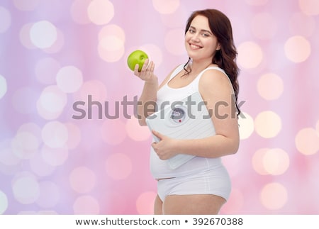 Foto stock: Happy Plus Size Woman In Underwear With Apple