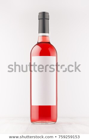 Stock photo: Rose Wine Bottle With Blank White Label On White Wooden Board Mock Up Vertical
