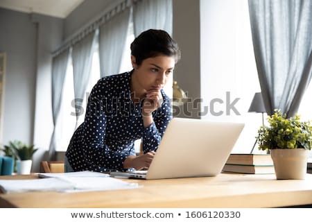 Stok fotoğraf: Serious Female Freelancer Working On Laptop Computer