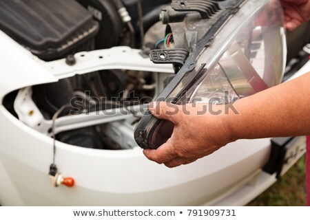 Stock fotó: Head Lights Repair Mechanic Holding A New Spare Part