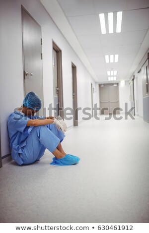 Foto stock: Sad Surgeon Sitting On A Floor