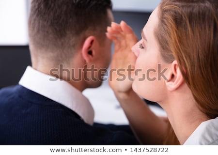 ストックフォト: Businesswoman Whispering Into Male Partners Ear