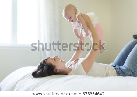 Stock photo: Portrait Of Parent With Her 3 Month Old Baby In Bedroom