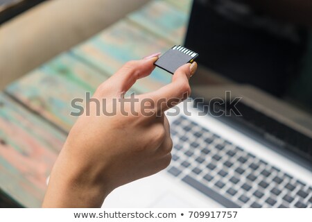 Foto d'archivio: Man And Woman Inserting Sd Cards