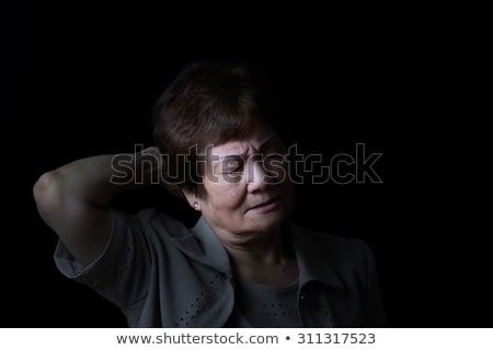 Senior Woman Touching Her Head While In Pain On Black Background ストックフォト © tab62