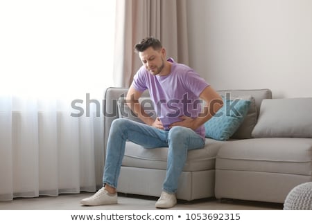 Foto stock: Man Suffering From Stomach Ache