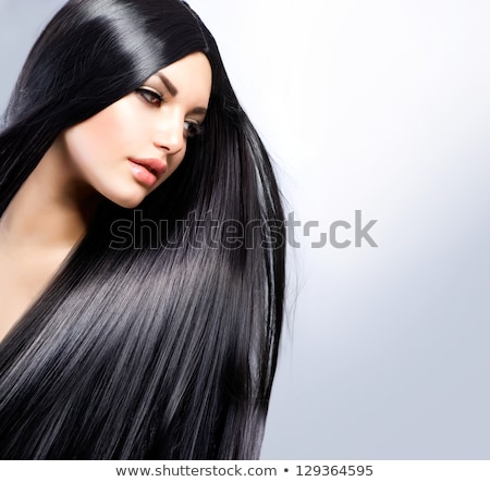 Foto stock: Brunette Woman With Long Straight Hair On Dark