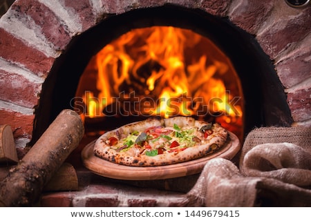 Foto d'archivio: Pizza Baking In Oven At Pizzeria