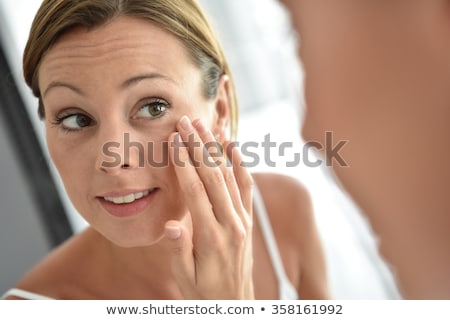 Stok fotoğraf: Woman Applying Moisturiser To Cheek