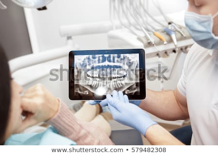 Сток-фото: Dentist Showing Teeth X Ray To Woman