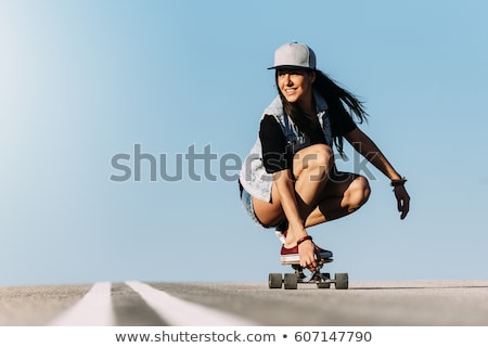 Сток-фото: Teenage Girls Riding Skateboard On City Street