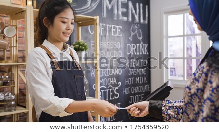 Stok fotoğraf: Two People Using Tablet And Creditdebit Card Register Payments
