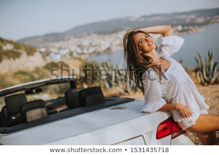 Zdjęcia stock: Pretty Young Woman By White Cabriolet Car On A Sunny Summer Day