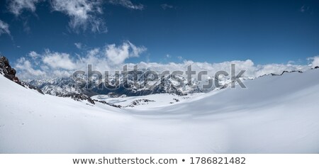 Foto stock: Top View To Caucasian Mountains Peaks Covered By Snow In Sunny Day