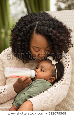 Stock photo: Woman Feeding Baby