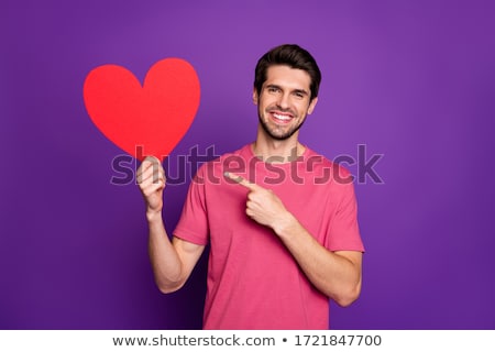 Stok fotoğraf: Romantic Young Casual Man Holding A Big Red Heart
