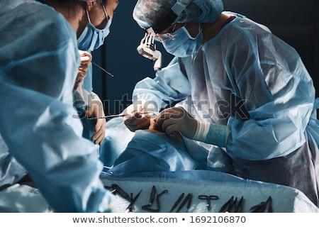 Foto d'archivio: Doctors And Surgeons Operating Patient In Hospital