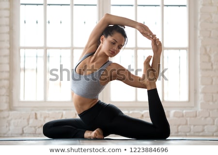 Foto stock: Young Woman Practicing Yoga In The Studio