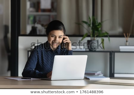 ストックフォト: Young Smiling Female Agent With Mobile Phone Consulting One Of Clients